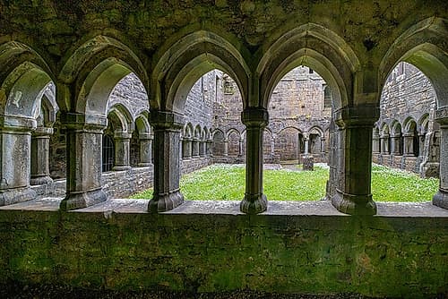 Ancient cloisters surround this patch of grass at Moyne Abbey-County Mayo-Ireland. Art Print